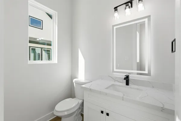 a view of a big room with wooden floor and bathroom