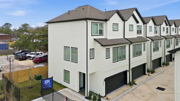 a front view of a residential houses with yard