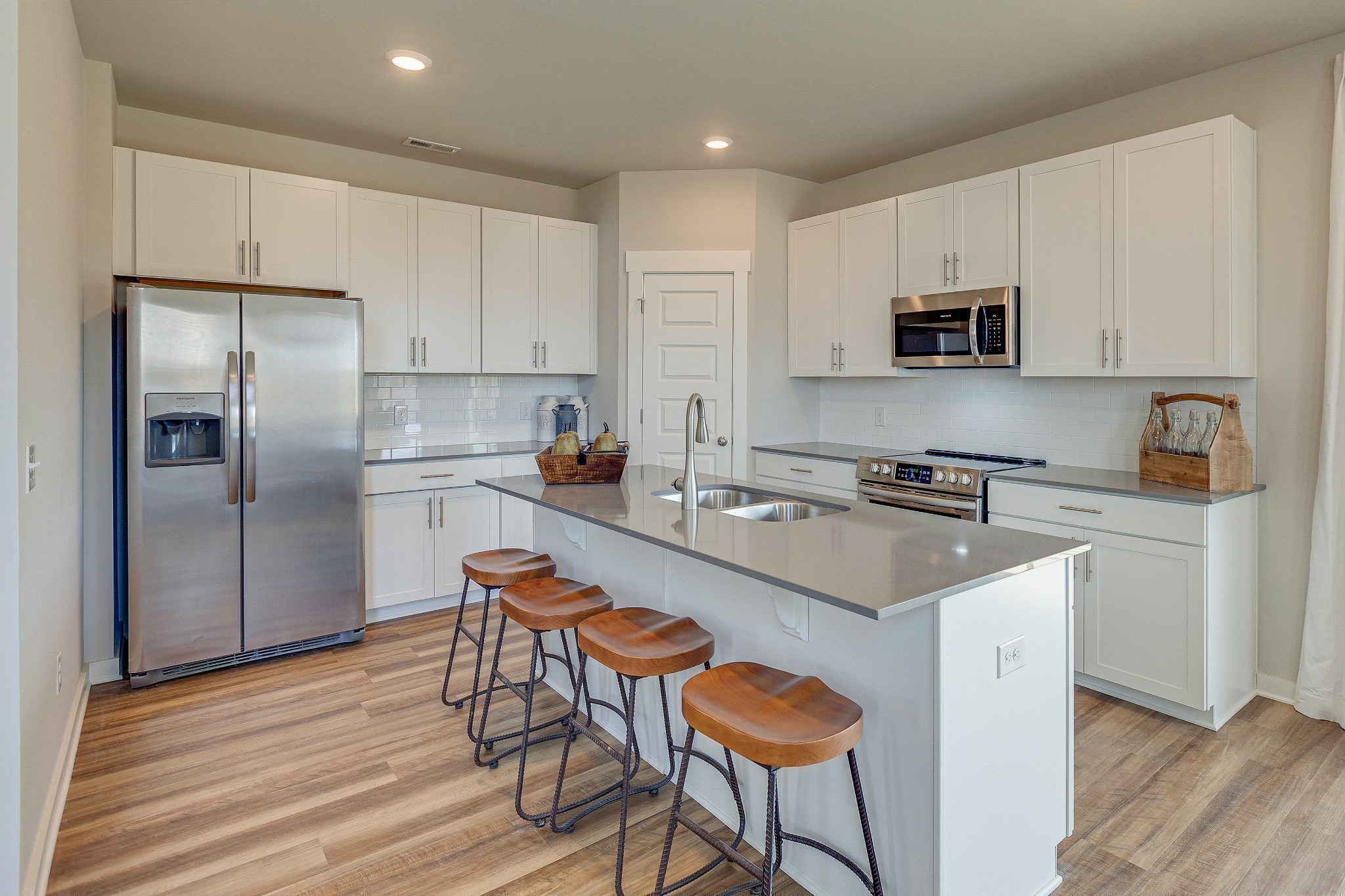 214 Goldfinch Road Mount Juliet, TN 37122 - Photo 8 of 24 a kitchen with stainless steel appliances a sink a stove a refrigerator cabinets and a dining table