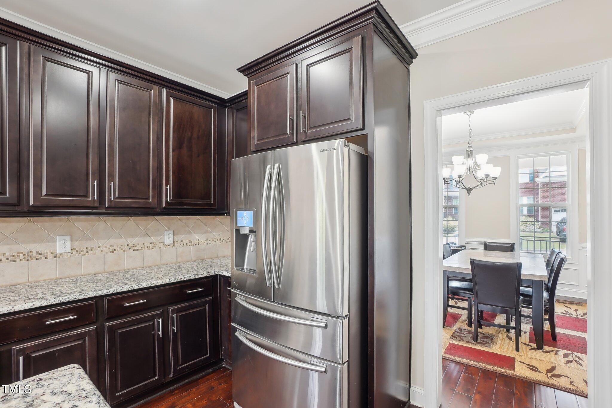4008 Sykes Street Cary, NC 27519 - Photo 9 of 41 a kitchen with granite countertop stainless steel appliances and wooden cabinets