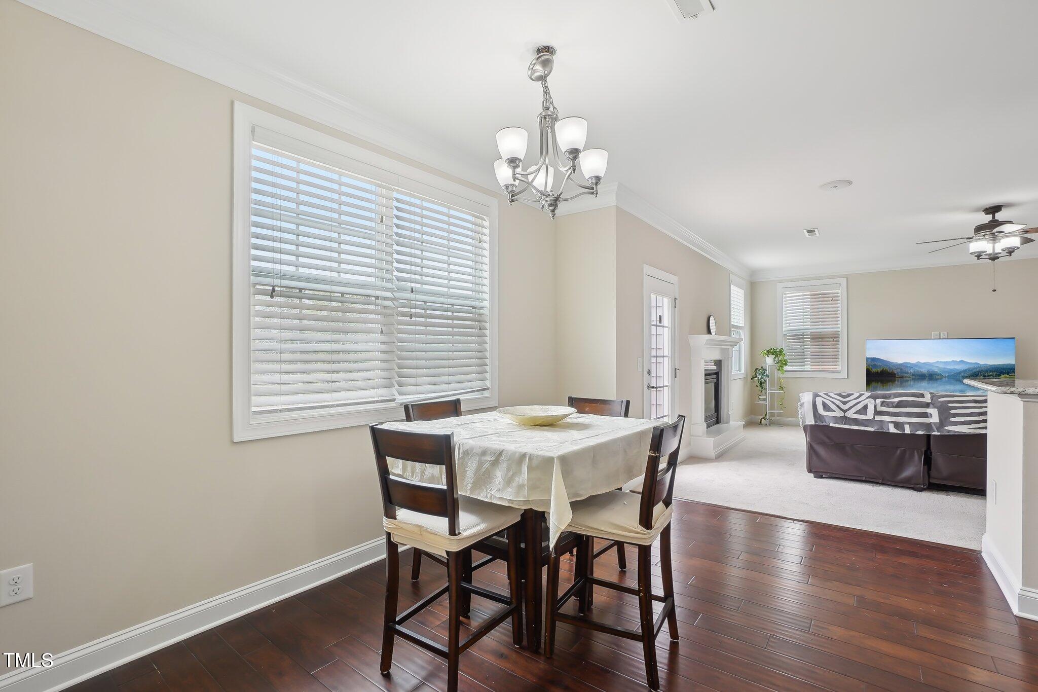 4008 Sykes Street Cary, NC 27519 - Photo 16 of 41 a view of a dining room with furniture window and wooden floor