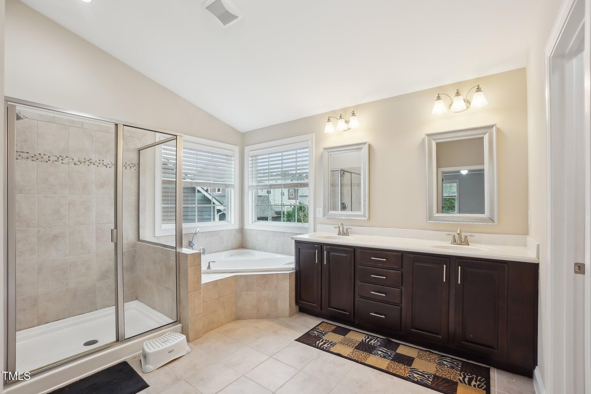 4008 Sykes Street Cary, NC 27519 - Photo 19 of 41 a bathroom with a tub sink shower and mirror