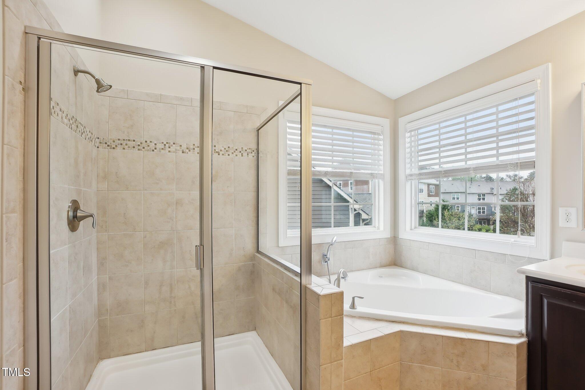 4008 Sykes Street Cary, NC 27519 - Photo 20 of 41 a bathroom with a bathtub and a shower