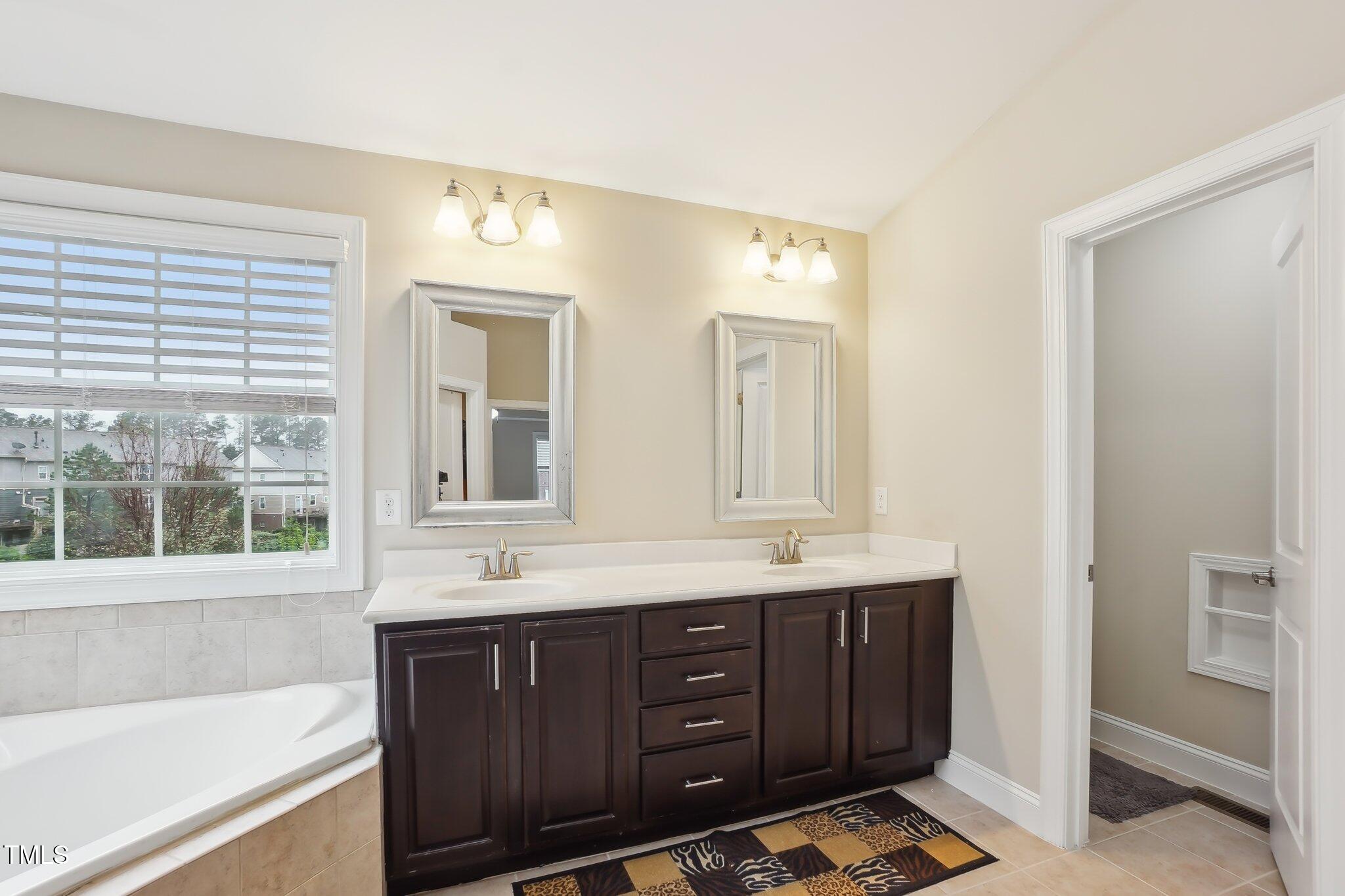4008 Sykes Street Cary, NC 27519 - Photo 21 of 41 a bathroom with a granite countertop sink mirror and double