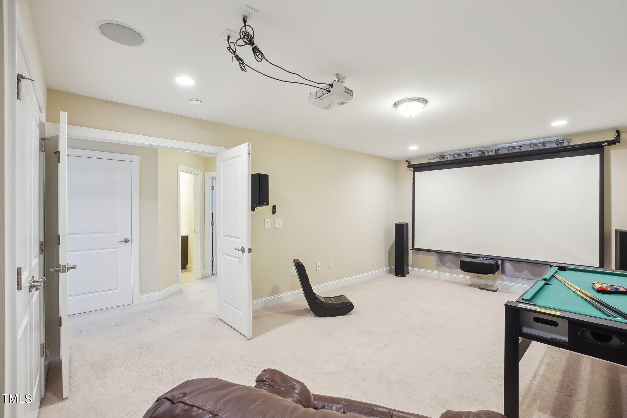 4008 Sykes Street Cary, NC 27519 - Photo 24 of 41 a room with furniture and a projector screen