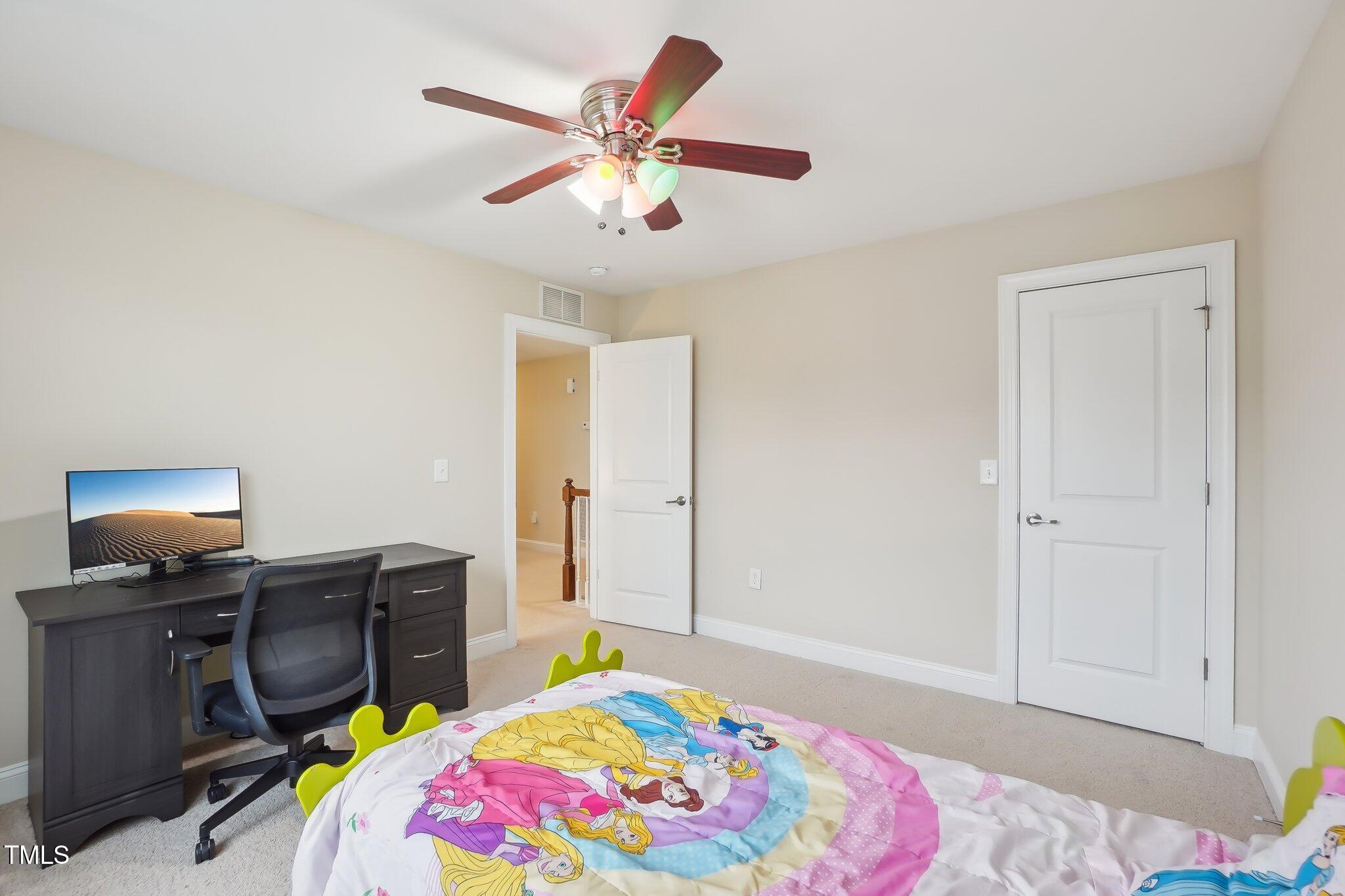 4008 Sykes Street Cary, NC 27519 - Photo 27 of 41 a bedroom with a bed and ceiling fan