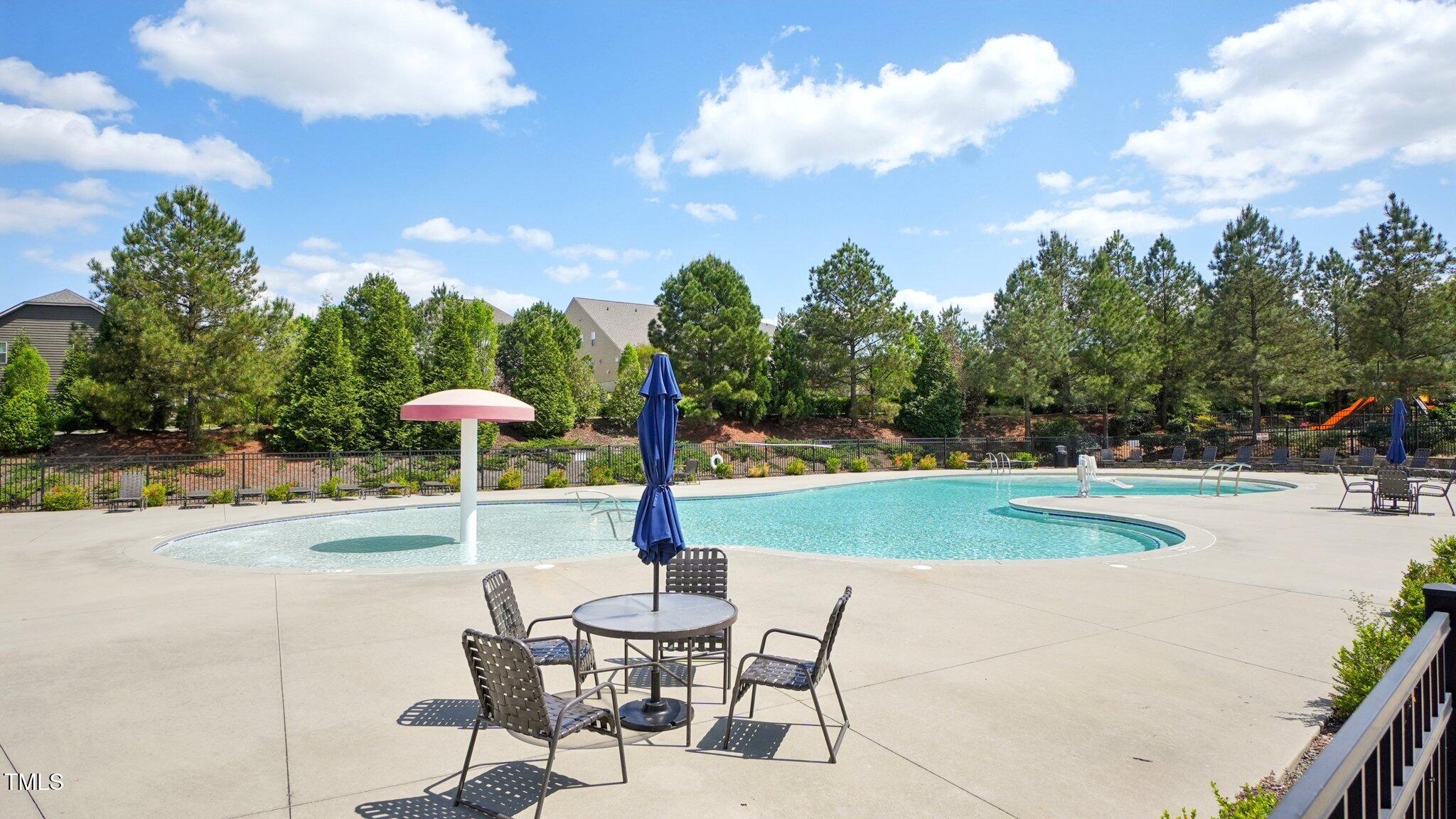 4008 Sykes Street Cary, NC 27519 - Photo 32 of 41 a swimming pool with lots of tress in front of it