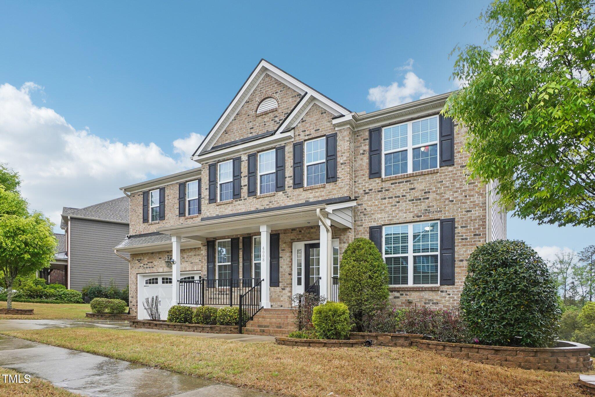 4008 Sykes Street Cary, NC 27519 - Photo 35 of 41 front view of a brick house with a yard
