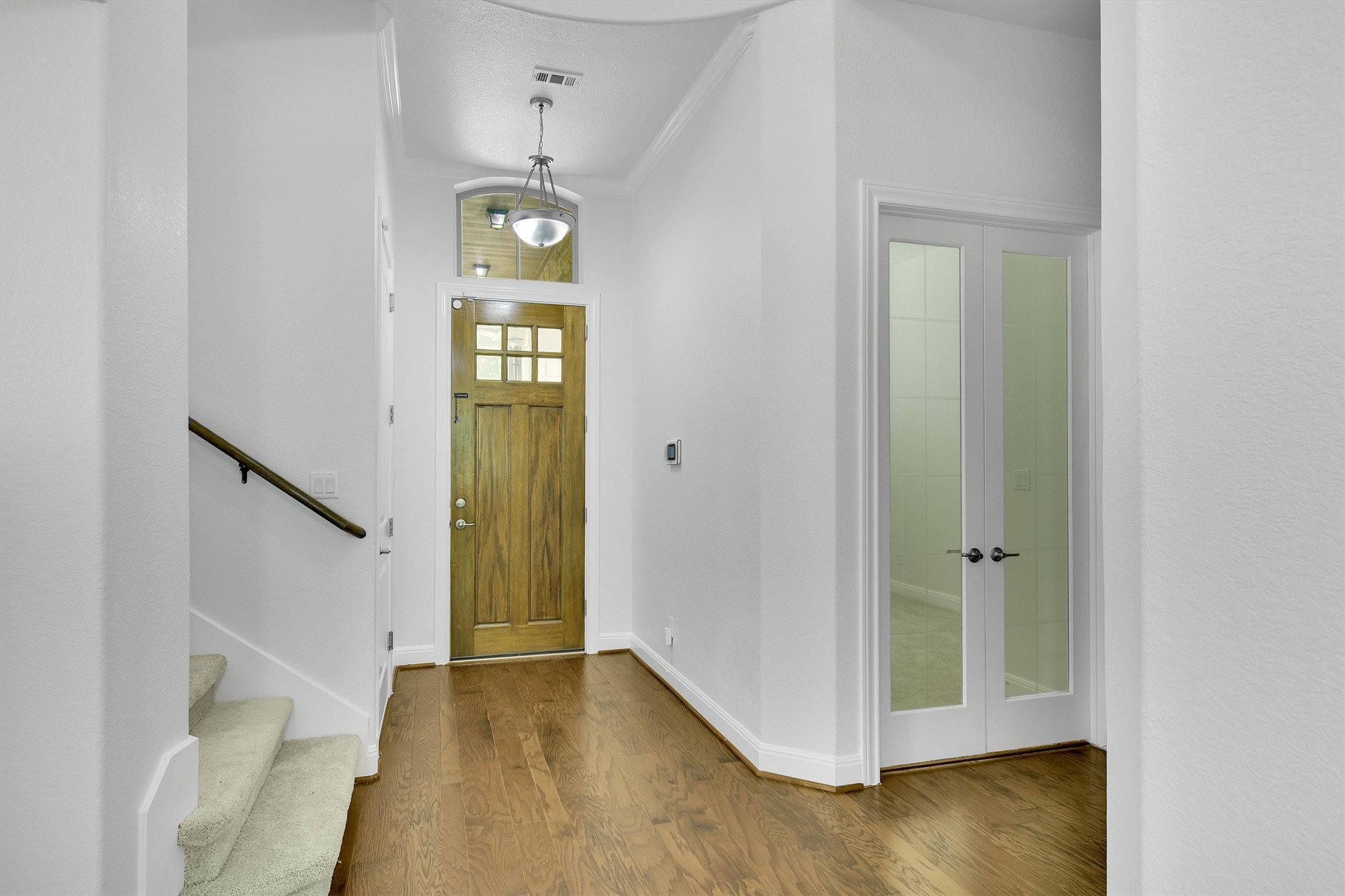 2325 Blended Tree Ranch Drive Leander, TX 78641 - Photo 6 of 35 A warm wooden entry door welcomes you to this sophisticated home with rich hardwood floors.