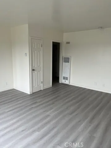 a view of an empty room and wooden floor