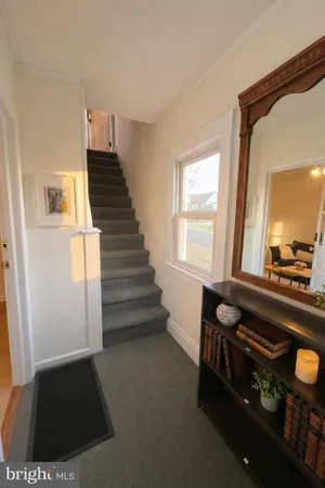 a view of entryway and hall with wooden floor
