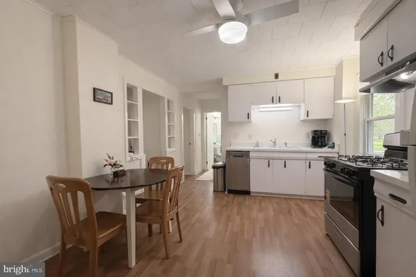 a kitchen with a table chairs stove and cabinets