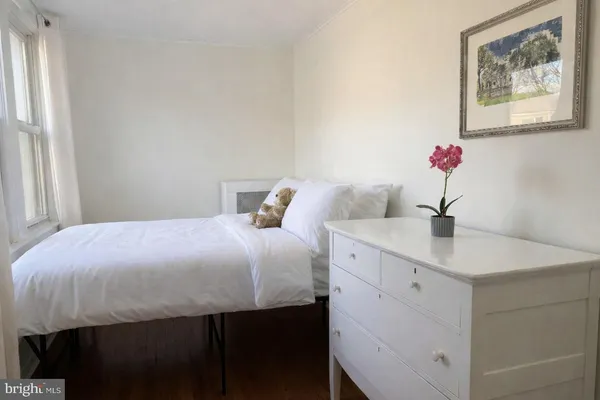 a bedroom with a bed and a sink