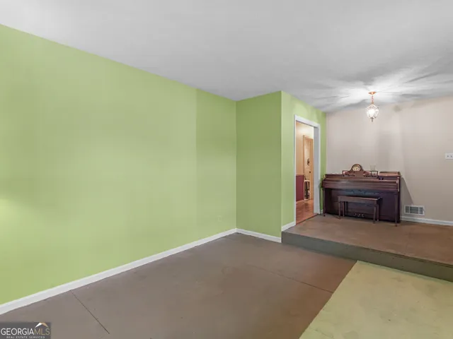 a kitchen with stainless steel appliances granite countertop a stove top oven a sink dishwasher a dining table and chairs with wooden floor