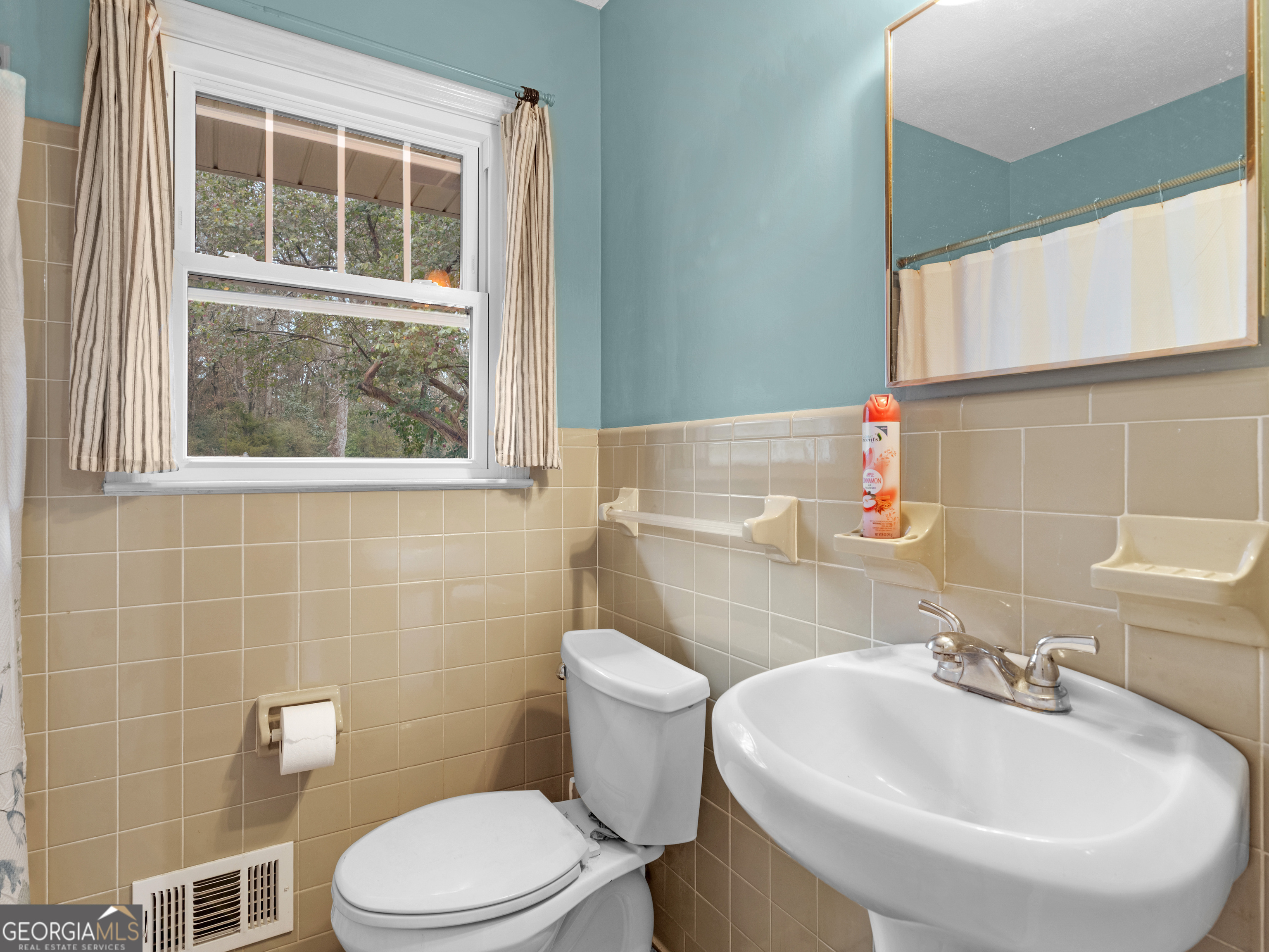 329 Pine Street Barnesville, GA 30204 - Photo 32 of 57 a bathroom with a sink a toilet and a mirror