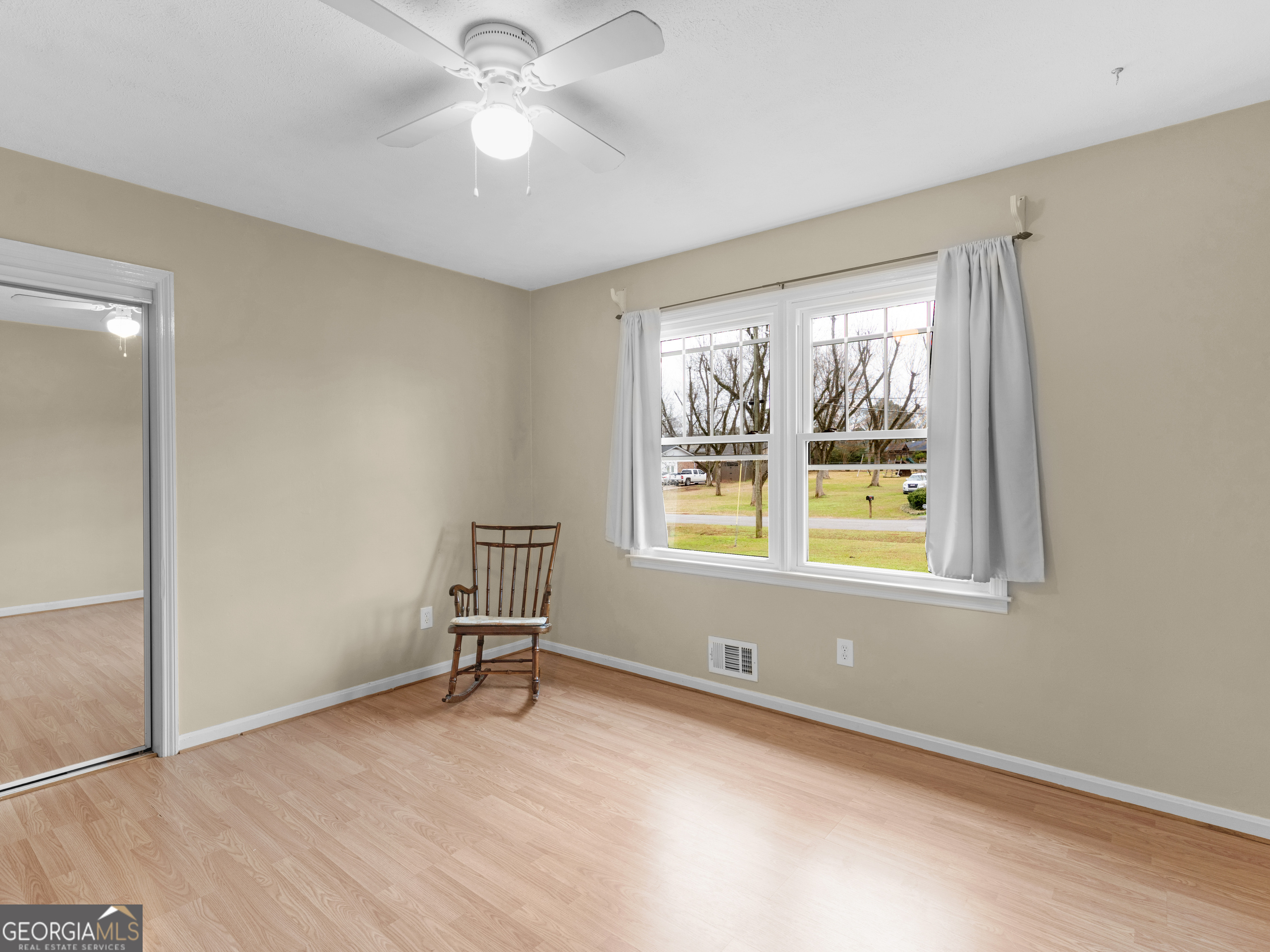 329 Pine Street Barnesville, GA 30204 - Photo 36 of 57 an empty room with windows and fan view
