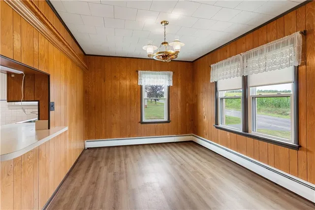 a view of a room with wooden floor and windows