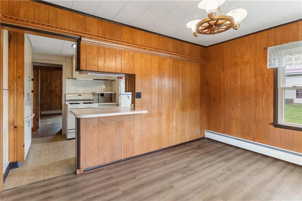177 Oniontown Road Greenville, PA 16125 - Photo 12 of 18 a kitchen with a refrigerator a stove cabinets and a dining table