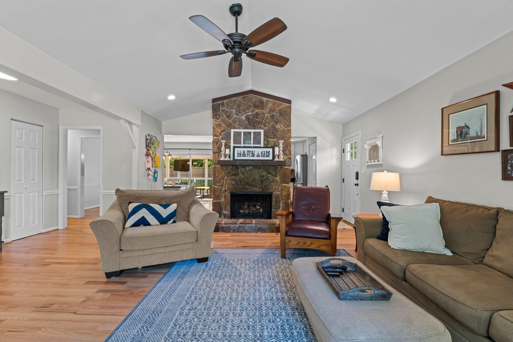 5421 Old Towne Road Raleigh, NC 27612 - Photo 6 of 39 Family Room features hardwood floors, smooth ceilings, flagstone fireplace, vaulted ceiling, and ceiling fan. Family Room