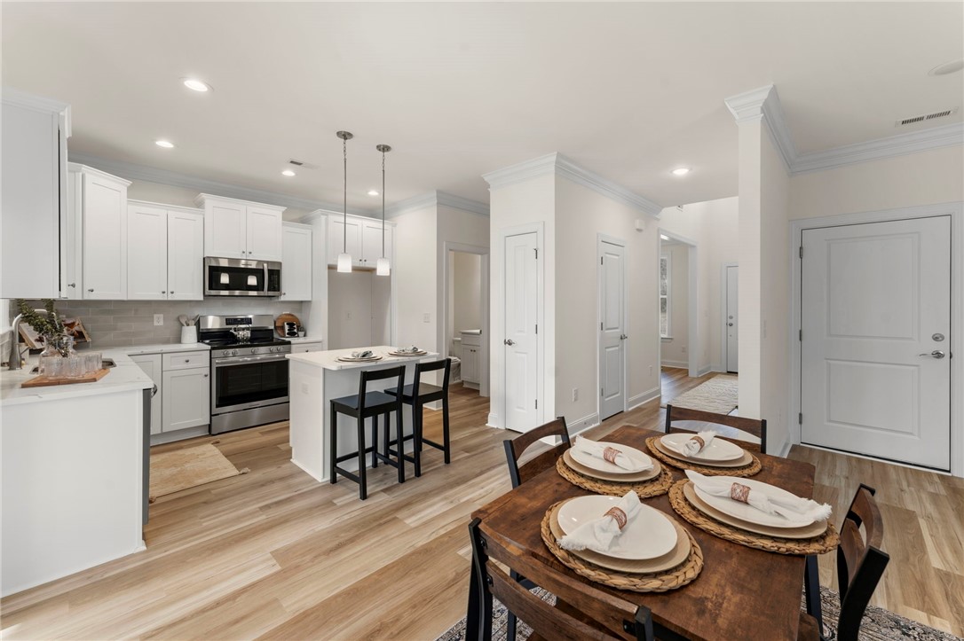 505 Fire Tower Road Williamston, SC 29697 - Photo 13 of 37 This open-concept kitchen and dining area features modern amenities and abundant natural light.