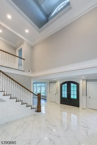 a dining room with furniture a chandelier and wooden floor