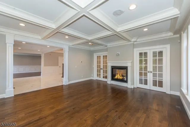 a kitchen with stainless steel appliances granite countertop a sink dishwasher a refrigerator and cabinets with wooden floor