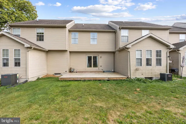 a view of a house with a yard and sitting area