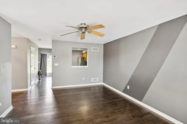 a view of empty room with wooden floor