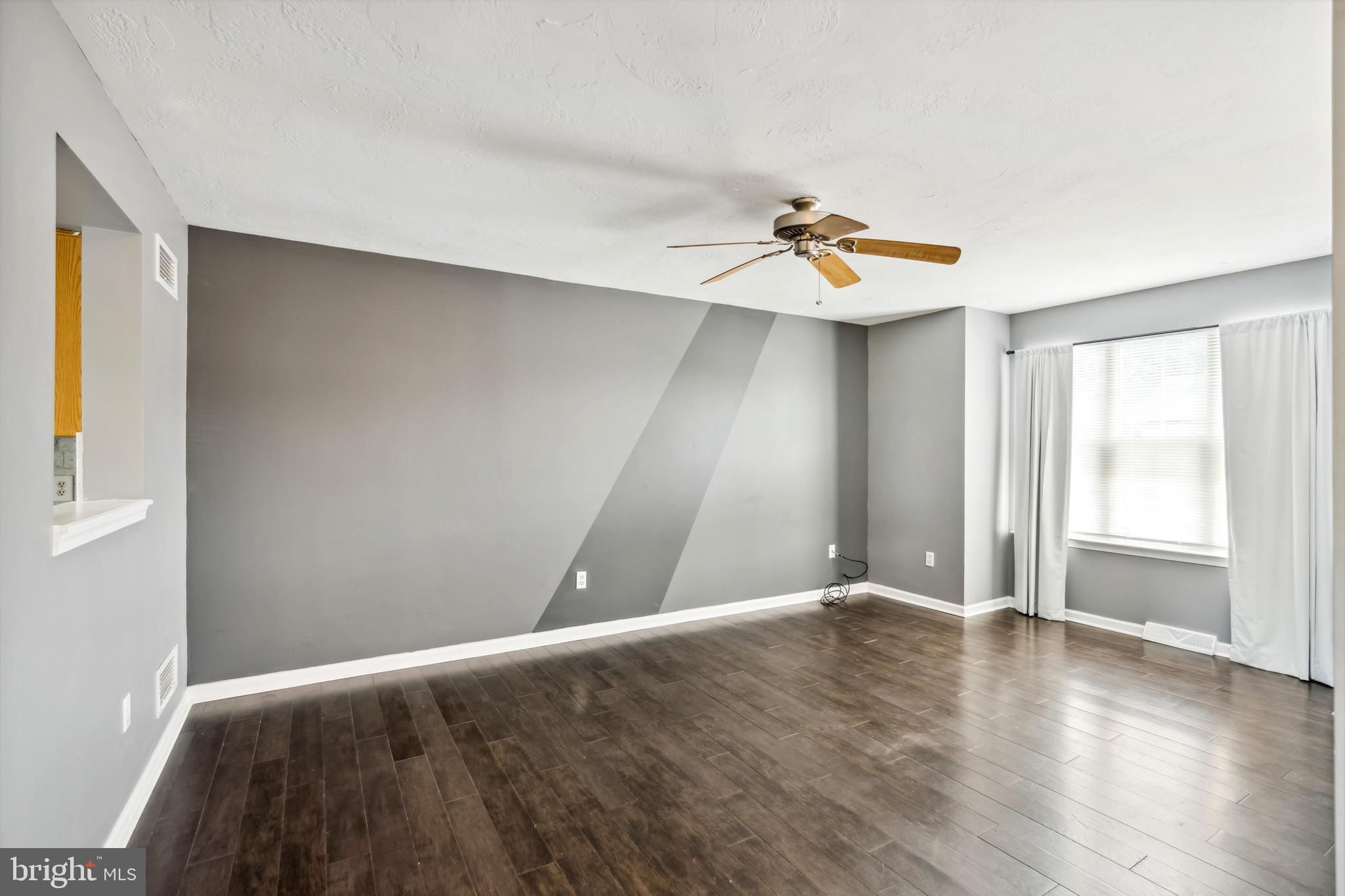 188 Sara Lane Hanover, PA 17331 - Photo 4 of 25 an empty room with wooden floor and windows