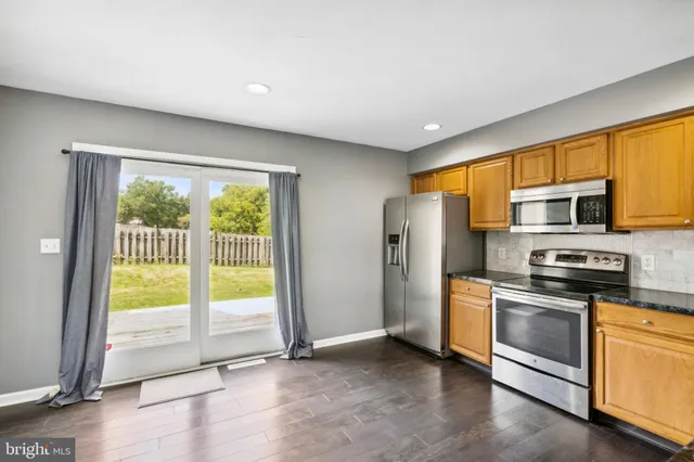 a kitchen with stainless steel appliances a refrigerator sink and stove
