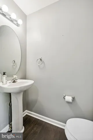 a bathroom with a sink mirror and toilet