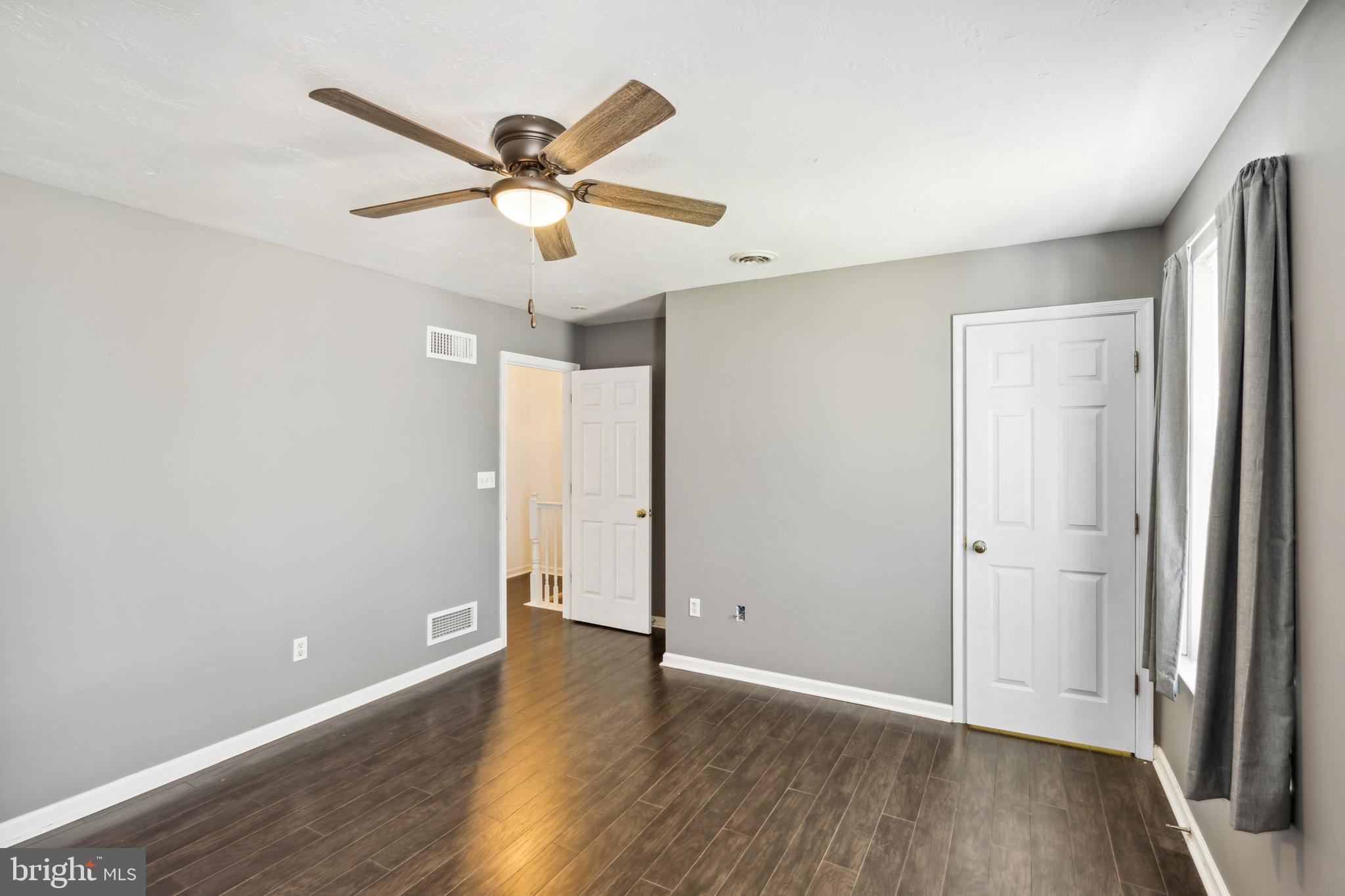 188 Sara Lane Hanover, PA 17331 - Photo 10 of 25 an empty room with wooden floor fan and windows