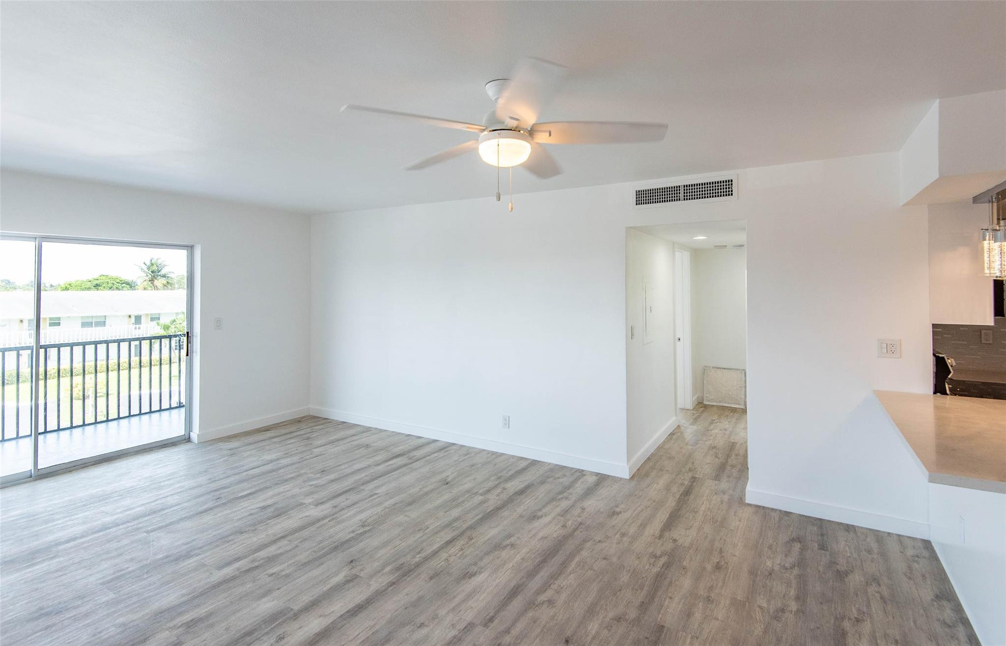 651 Pine Drive, Unit 306 Pompano Beach, FL 33060 - Photo 15 of 36 wooden floor in an empty room with a window