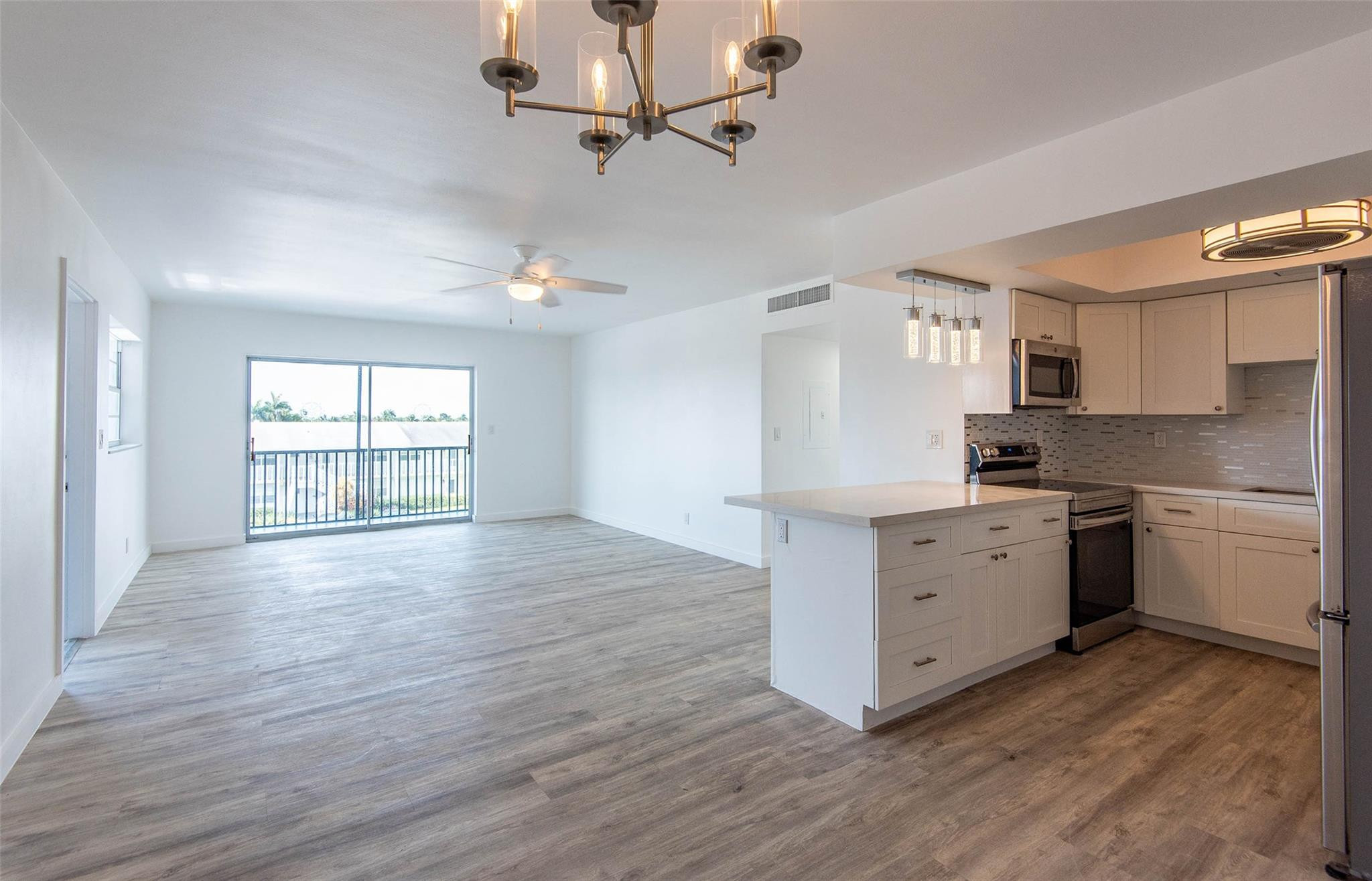 651 Pine Drive, Unit 306 Pompano Beach, FL 33060 - Photo 18 of 36 a kitchen with granite countertop a stove cabinets and wooden floor