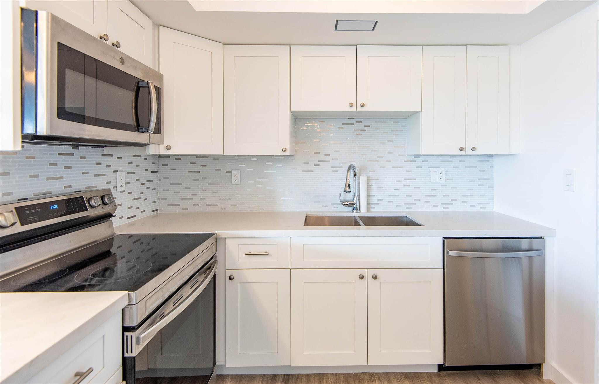 651 Pine Drive, Unit 306 Pompano Beach, FL 33060 - Photo 20 of 36 a kitchen with cabinets appliances and a sink