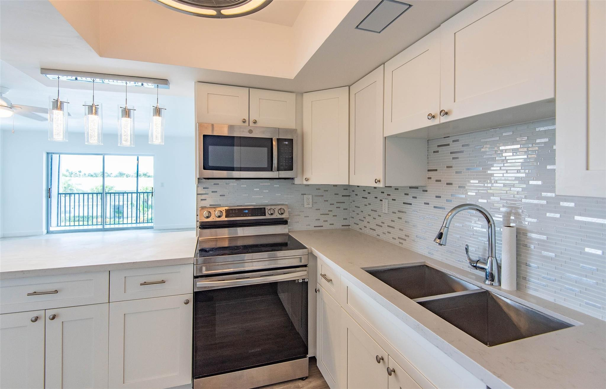 651 Pine Drive, Unit 306 Pompano Beach, FL 33060 - Photo 21 of 36 a kitchen with appliances a sink and cabinets