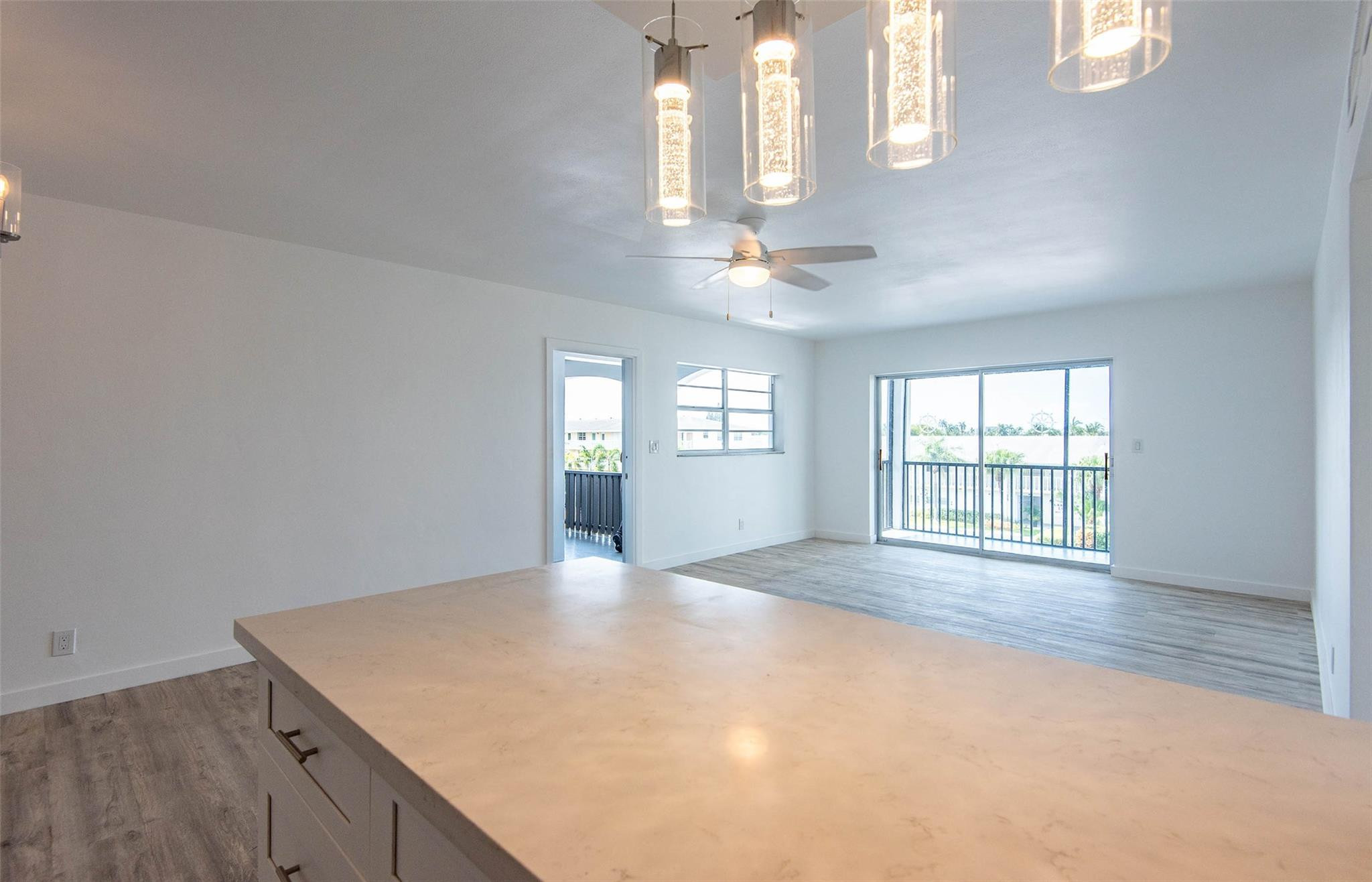 651 Pine Drive, Unit 306 Pompano Beach, FL 33060 - Photo 23 of 36 wooden floor in an empty room with a window