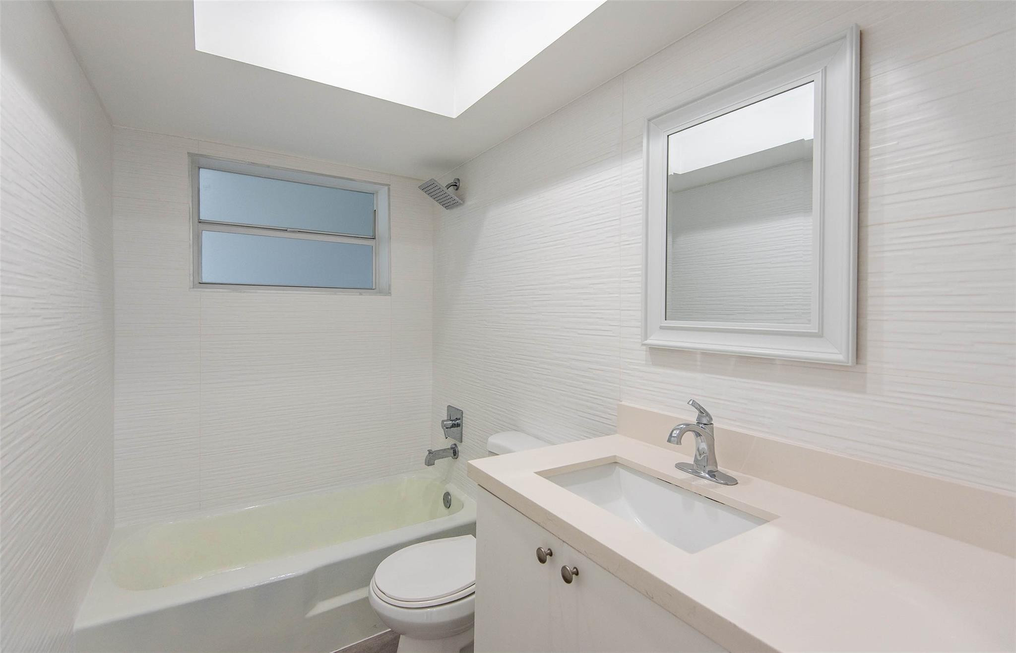 651 Pine Drive, Unit 306 Pompano Beach, FL 33060 - Photo 24 of 36 a bathroom with a sink toilet tub and vanity