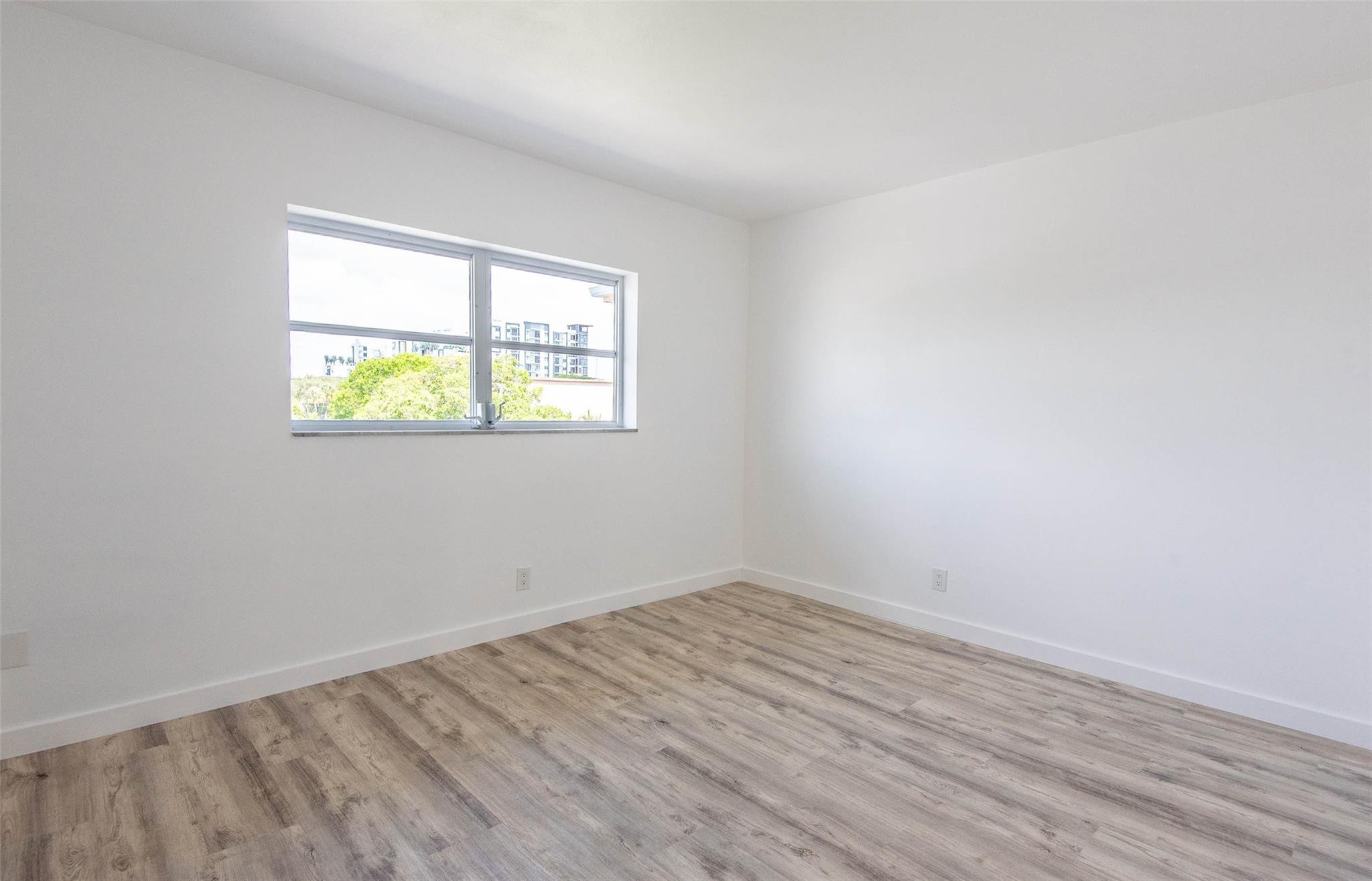 651 Pine Drive, Unit 306 Pompano Beach, FL 33060 - Photo 27 of 36 an empty room with a window