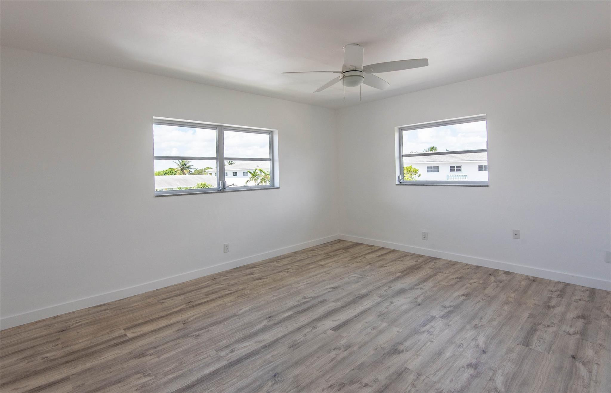 651 Pine Drive, Unit 306 Pompano Beach, FL 33060 - Photo 30 of 36 a view of empty room with wooden floor and fan