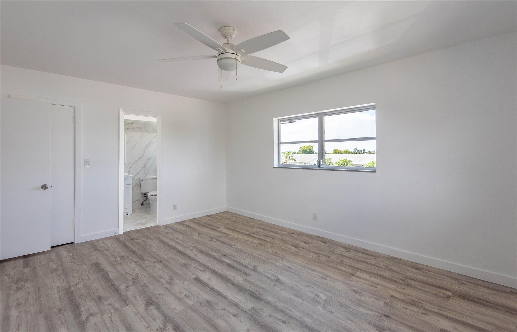 651 Pine Drive, Unit 306 Pompano Beach, FL 33060 - Photo 31 of 36 wooden floor in an empty room with a window