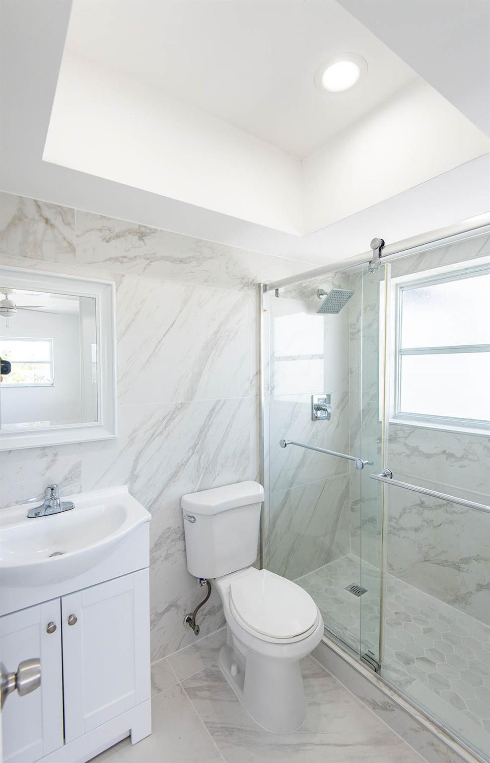 651 Pine Drive, Unit 306 Pompano Beach, FL 33060 - Photo 32 of 36 a bathroom with a toilet shower vanity and a sink