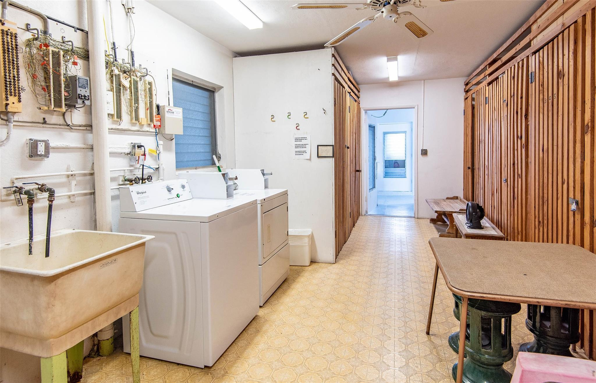 651 Pine Drive, Unit 306 Pompano Beach, FL 33060 - Photo 34 of 36 a room with a sink dishwasher a dining table and chairs with wooden floor