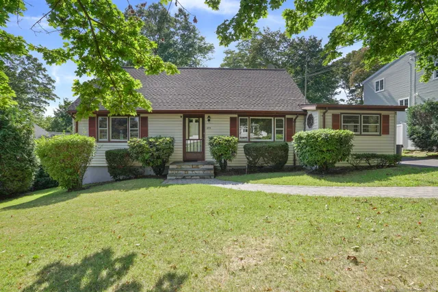 a front view of a house with a garden