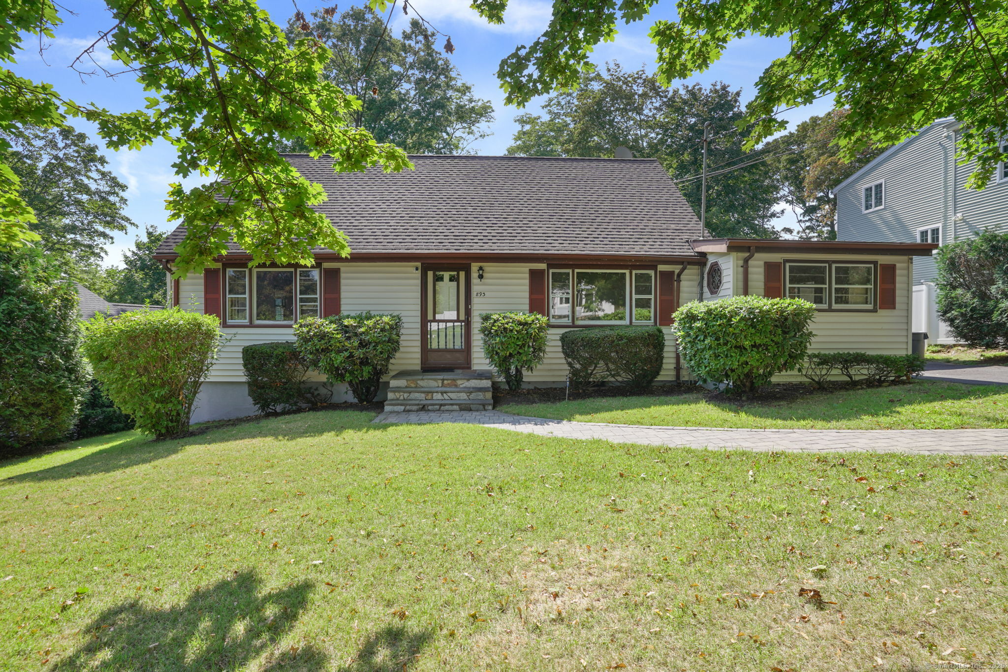 a front view of a house with a garden