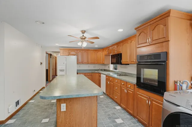 a kitchen with stainless steel appliances granite countertop a sink and refrigerator