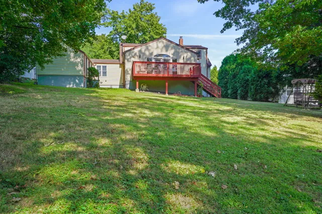 a sign board with lawn chairs and trees