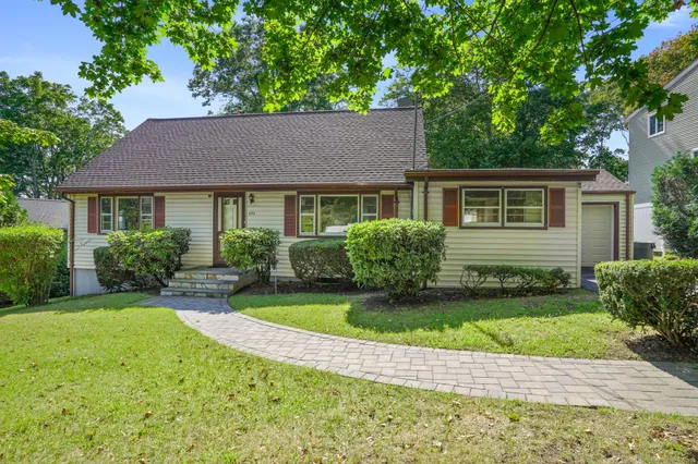 a house that has a tree in front of it