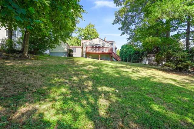 a backyard of a house with table and chairs