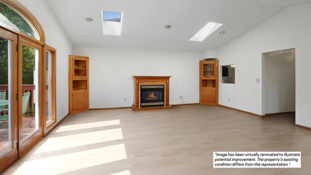 a view of an empty room with a fireplace and a window